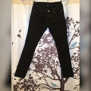 Worn stretchy black denim straight mid waist jean